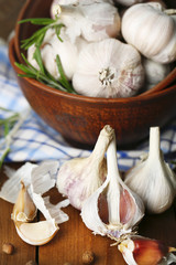 Raw garlic and spices on wooden table