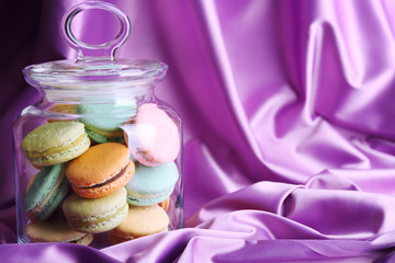 Gentle colorful macaroons in glass jar