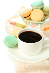 Gentle colorful macaroons in glass bowl and black coffee in mug
