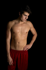 Fototapeta premium man no shirt red shorts stand on black hand hip