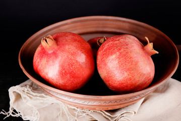 Juicy ripe pomegranates on dark background