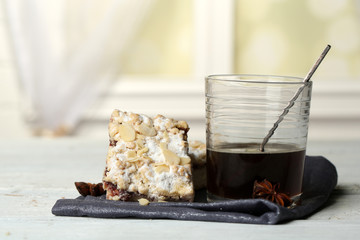 Glass of espresso and tasty homemade pie on wooden table