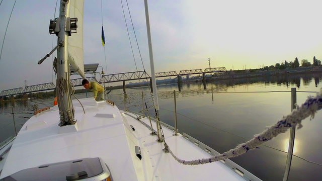 Young man on sailing yacht, city river, landscape, active rest