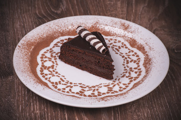 Chocolate cake slice on white plate