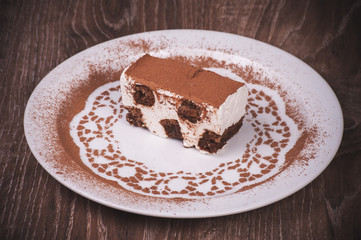 tiramisu dessert slice on white plate