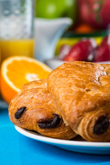 Chocolate croissant with orange juice