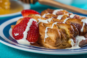 Continental croissant with fresh organic cream and strawberries