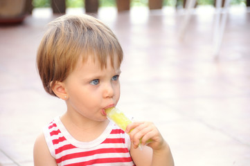 blue eyed girl sucking a lemon ice cream