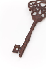 Vintage Old Key on white background. Selective focus.