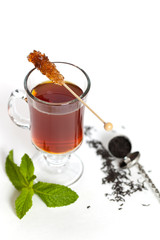 Tea with Mint Leaf and Candy Brown Sugar on a Sticks