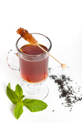 Tea with Mint Leaf and Candy Brown Sugar on a Sticks