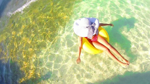 girl enjoy relaxing on inflamable rubber ring