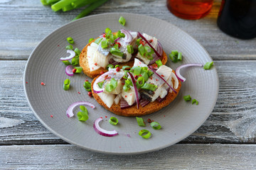 canapes with herring and onions