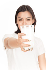 Laughing young woman with a glass of milk