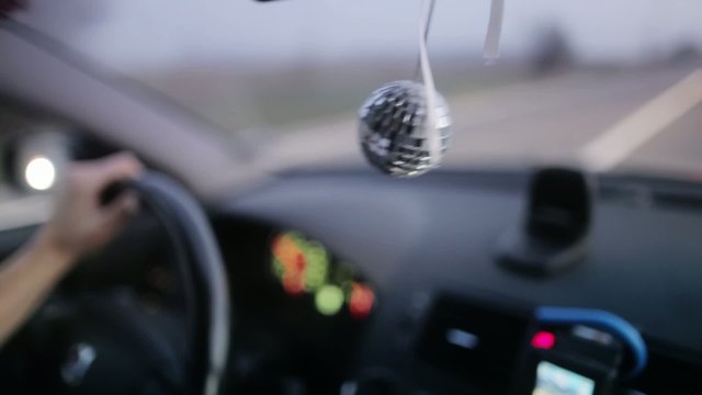Disco ball hanging in the car