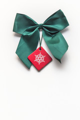 Green Christmas ribbon and red star on white background