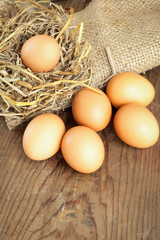 yellow organic eggs with straw