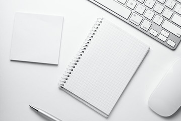 Spiral Notes Surrounded by Office Stuffs on Table