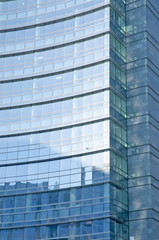 Obraz premium Glass Facade of company building with reflection of blue sky.