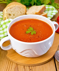 Soup tomato with pepper in bowl on board