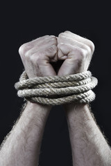 white man hands wrapped rope around wrists victim abused concept