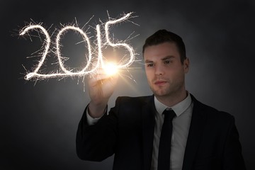 Composite image of businessman touching spark