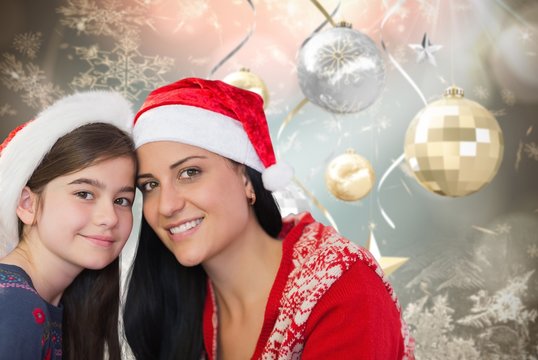 Composite image of mother and daughter in santa hats