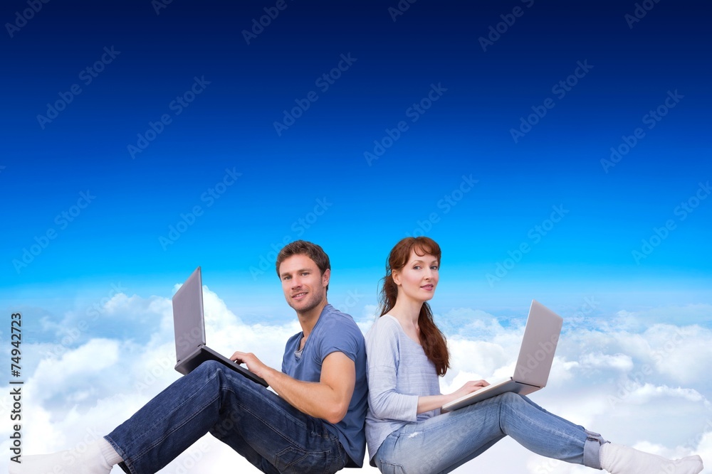 Aufkleber Composite image of couple both using laptops separately