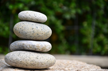 Fototapeta na wymiar Stack of zen rocks in garden