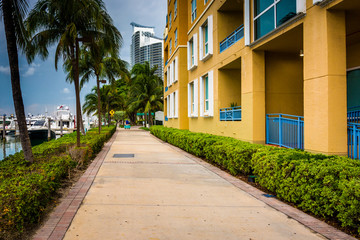 Fototapeta na wymiar Condominiums and marina along a walkway in South Beach, Miami, F