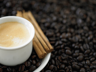 A cup of cafe latte with coffee beans