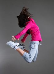 Fototapeta na wymiar Modern hip-hop style teenage girl jumping