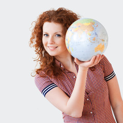 Young woman holding globe