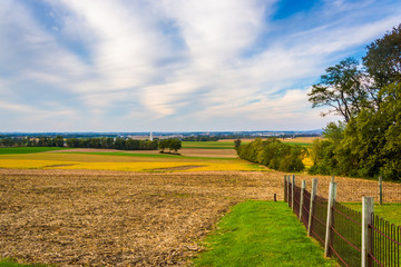 Fence and view of farm fields in rural Lancaster County, Pennsyl