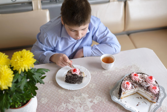 Boy eating cake at  table