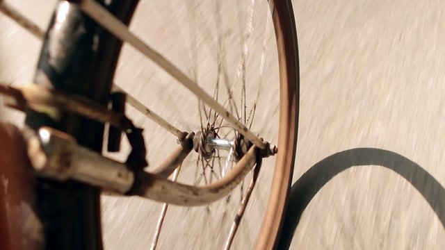 rusty wheel riding  bicycle on road