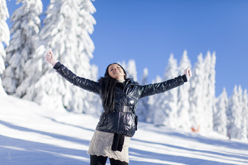 Fototapeta na wymiar Young woman on the mountain at winter