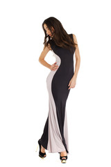 Fototapeta premium Portrait in full growth of a young woman in long evening dress