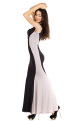 Portrait in full growth of a young woman in long evening dress