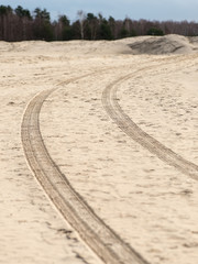 car tyre tracks on the beach sand