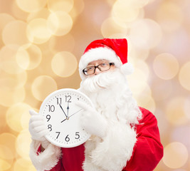 man in costume of santa claus with clock