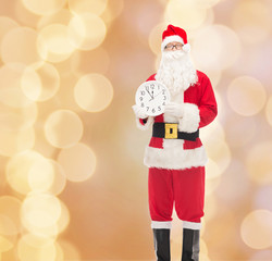 man in costume of santa claus with clock