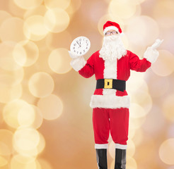 man in costume of santa claus with clock