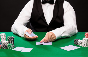holdem dealer with playing cards and casino chips