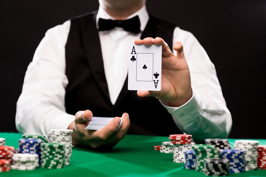 Holdem Dealer With Playing Cards And Casino Chips