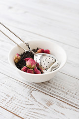 Tea strainer and rose buds