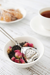 Tea strainer and rose buds