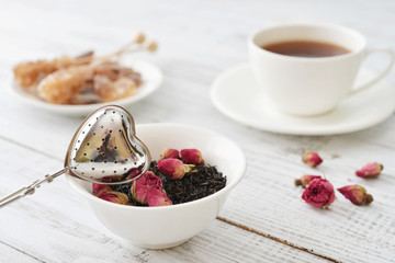 Tea strainer and rose buds