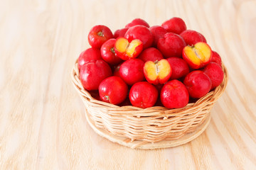 Red acerola - malpighia glabra, tropical fruit  in wicker busket