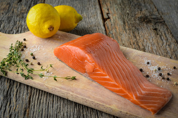Salmon on a Cutting Board with Lemon, Salt and Pepper